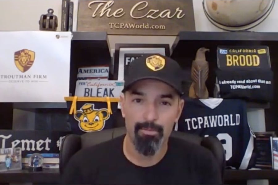 TCPA Czar Eric J. Troutman in front of a TCPAWorld.com The Czar backdrop. youtube screenshot.